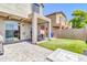 An inviting backyard features a covered patio, pavers, artificial turf, and a built in fireplace at 1350 S Greenfield Rd # 1166, Mesa, AZ 85206