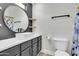 Modern bathroom featuring a vessel sink, round mirror, wood shelves, and contemporary fixtures at 1350 S Greenfield Rd # 1166, Mesa, AZ 85206