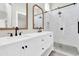 Bathroom featuring double vanity, wooden framed mirrors, white shaker cabinets and a walk-in glass shower at 1350 S Greenfield Rd # 1166, Mesa, AZ 85206