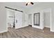 Bedroom with laminate flooring, white walls, and mirror closet at 1350 S Greenfield Rd # 1166, Mesa, AZ 85206