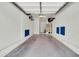 A spacious two-car garage with overhead storage racks, water heater, and access door at 1350 S Greenfield Rd # 1166, Mesa, AZ 85206