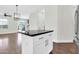 A kitchen island with black countertops, white cabinets, and modern pendant lighting at 1350 S Greenfield Rd # 1166, Mesa, AZ 85206