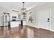 Modern kitchen with white cabinets, stainless steel appliances, and an island open to the dining area at 1350 S Greenfield Rd # 1166, Mesa, AZ 85206