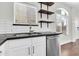 Kitchen sink and white cabinetry with wooden shelves and stainless steel appliances at 1350 S Greenfield Rd # 1166, Mesa, AZ 85206