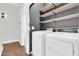 Laundry room featuring washer and dryer with wood shelving at 1350 S Greenfield Rd # 1166, Mesa, AZ 85206