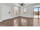 Open living room with wood floors, arched windows, and a glass patio door leading to the yard at 1350 S Greenfield Rd # 1166, Mesa, AZ 85206