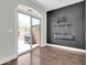 Bright living room featuring luxury vinyl plank floors, a fireplace, and an access to the backyard at 1350 S Greenfield Rd # 1166, Mesa, AZ 85206