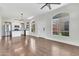 Inviting open-concept living space with wood floors, modern lighting, and view of the kitchen at 1350 S Greenfield Rd # 1166, Mesa, AZ 85206