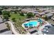 Aerial view of community pool with cabanas, lounge chairs, and well-manicured landscaping near residential homes at 1350 S Greenfield Rd # 1166, Mesa, AZ 85206
