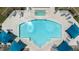 Aerial view of a sparkling blue community pool with sunshades and ample lounge seating at 1350 S Greenfield Rd # 1166, Mesa, AZ 85206