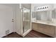Well-lit bathroom with double sinks, a glass-enclosed shower, and tile flooring at 14235 W Shawnee Trl, Surprise, AZ 85374