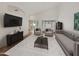 Cozy living room with neutral decor, a plush rug, and ample natural light at 14235 W Shawnee Trl, Surprise, AZ 85374