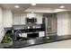 Modern kitchen with stainless steel appliances and granite countertops at 1432 W Emerald Ave # 51, Mesa, AZ 85202