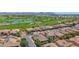 Stunning aerial view of a residential community with lush golf courses, lakes, and beautiful homes with tiled roofs at 1462 E Sweet Citrus Dr, Queen Creek, AZ 85140