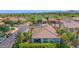 Aerial of a community with well-maintained homes, desert landscaping, and a beautiful golf course in the distance at 1462 E Sweet Citrus Dr, Queen Creek, AZ 85140