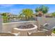 Serene backyard with a stone fire pit and comfortable seating area at 1462 E Sweet Citrus Dr, Queen Creek, AZ 85140