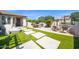 Outdoor living space with modern patio, lounge seating, and artificial turf at 1462 E Sweet Citrus Dr, Queen Creek, AZ 85140