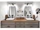 Modern bathroom featuring double sinks, custom mirrors, and modern lighting at 1462 E Sweet Citrus Dr, Queen Creek, AZ 85140