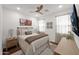 Bright bedroom with a queen-size bed, ceiling fan, and natural light at 1462 E Sweet Citrus Dr, Queen Creek, AZ 85140