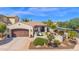 Beautiful home featuring a well-manicured lawn, desert landscaping, and a two-car garage at 1462 E Sweet Citrus Dr, Queen Creek, AZ 85140