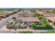 Aerial view of a single-story home with a manicured yard, featuring a private outdoor lounge and desert landscaping at 1462 E Sweet Citrus Dr, Queen Creek, AZ 85140