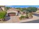 Aerial view of a well-maintained property with a desert landscape, a two-car garage, and a private gated courtyard at 1462 E Sweet Citrus Dr, Queen Creek, AZ 85140