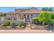 Charming front yard with desert landscaping, including decorative rocks and lush plants, leading to a private gated courtyard at 1462 E Sweet Citrus Dr, Queen Creek, AZ 85140