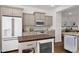 Updated kitchen boasts gray cabinets, stainless steel appliances, and stylish countertops at 1462 E Sweet Citrus Dr, Queen Creek, AZ 85140