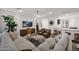 Cozy living room includes large sectional sofa, leather chairs, and stylish furnishings at 1462 E Sweet Citrus Dr, Queen Creek, AZ 85140