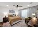 Bright main bedroom suite with a plush bed, designer accents, and a ceiling fan at 1462 E Sweet Citrus Dr, Queen Creek, AZ 85140