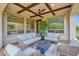 Cozy covered patio with outdoor seating and a modern fire pit at 1462 E Sweet Citrus Dr, Queen Creek, AZ 85140