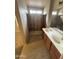 Bathroom featuring tile floors, a double sink vanity, and shower at 1546 W Vaughn Ave, Gilbert, AZ 85233