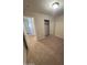 This bedroom features a neutral carpet, sliding door closet, and light fixture at 1546 W Vaughn Ave, Gilbert, AZ 85233