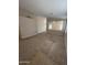 An empty living room with neutral carpet, ceiling fan, and large picture window at 1546 W Vaughn Ave, Gilbert, AZ 85233