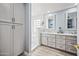 Bright bathroom with dual sinks, granite countertops, and a step-in shower with glass block window at 1638 N Avoca --, Mesa, AZ 85207