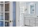 Stylish bathroom featuring double vanities, and a step-in shower with tiled walls and glass block window at 1638 N Avoca --, Mesa, AZ 85207