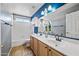 Bathroom featuring double sinks, tile floor, and an oversized mirror with decorative lights at 1638 N Avoca --, Mesa, AZ 85207
