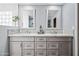 Elegant bathroom showcasing a double vanity with granite countertops and backsplash with dual mirrors at 1638 N Avoca --, Mesa, AZ 85207