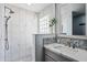 Step-in shower featuring marble tiled walls, glass block window, and a rainfall shower head at 1638 N Avoca --, Mesa, AZ 85207