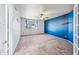 Spacious bedroom featuring blue accent wall, plush carpet, and a ceiling fan at 1638 N Avoca --, Mesa, AZ 85207
