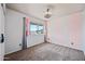 Bedroom featuring pink striped accent wall, neutral carpet, and a bright window with exterior view at 1638 N Avoca --, Mesa, AZ 85207