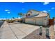 View of the home's exterior showcasing the long driveway and a desert landscaped yard at 1638 N Avoca --, Mesa, AZ 85207