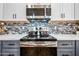 Modern kitchen features stainless appliances and hardware, tiled backsplash and stylish cabinets at 1638 N Avoca --, Mesa, AZ 85207