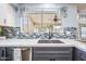 Updated kitchen features stainless dishwasher and sink, modern tile backsplash and grey lowers at 1638 N Avoca --, Mesa, AZ 85207