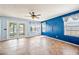 Bright living room features tile flooring, ceiling fan, and glass doors to the backyard at 1638 N Avoca --, Mesa, AZ 85207