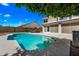 Backyard pool and spa next to the home with lush surrounding vegetation at 1638 N Avoca --, Mesa, AZ 85207