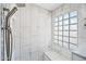 Shower with marble tile and a glass block window at 1638 N Avoca --, Mesa, AZ 85207