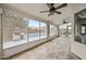 Enclosed sunroom with a ceiling fan and large windows that show a backyard pool and grill at 1638 N Avoca --, Mesa, AZ 85207