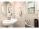 Clean and bright powder room with a pedestal sink and contemporary fixtures at 1849 E Chelsea Ln # 107, Gilbert, AZ 85295