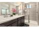 This bathroom has a double vanity with quartz counters and a walk-in shower with glass doors at 1849 E Chelsea Ln # 107, Gilbert, AZ 85295